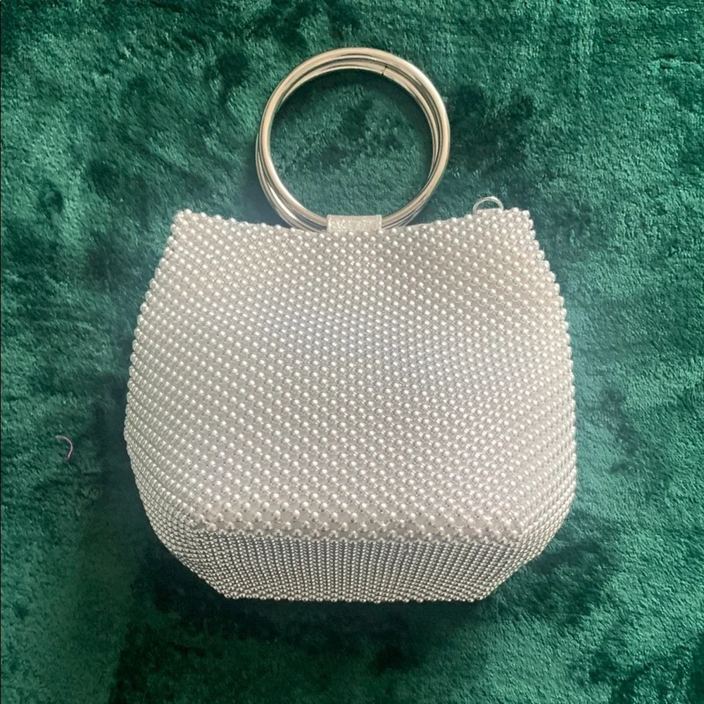NWOT Silver Wristlet. Metal Handle & crossbody chain strap.